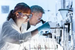 Scientists conducting laboratory research using equipment and test tubes for scientific analysis