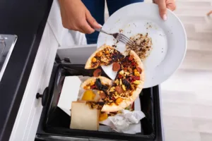 Throwing leftover food into trash which can attract pests indoors